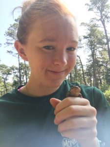 Audrey Boraski holding a toad and smiling