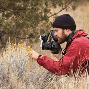 Charley Eiseman taking a photograph of an insect/plant